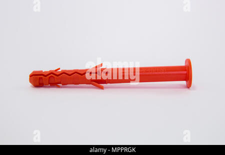 One plastic orange dowel on white background Stock Photo