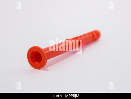 One plastic orange dowel on white background Stock Photo