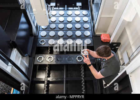 Man examining workpiece in factory Stock Photo