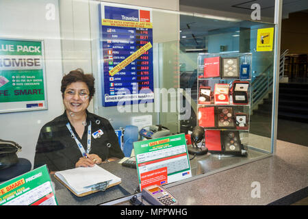 Toronto Canada,Lester B. Pearson International Airport,YYZ,aviation,terminal,currency exchange booth,foreign money,Asian woman female women,cashier,wo Stock Photo
