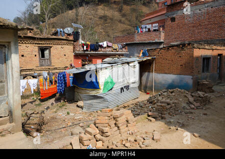 Temporary shelter on demolished house site, after 2015 earthquake, Panauti, Nepal Stock Photo