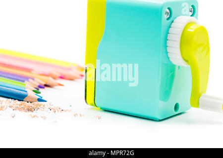 pastel blue yellow rotary pencil sharpener shavings with wooden colorful pencils isolated on white background, back to school education concept Stock Photo