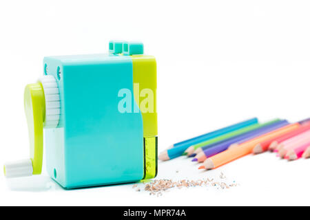 pastel blue yellow rotary pencil sharpener shavings with wooden colorful pencils isolated on white background, back to school education concept Stock Photo
