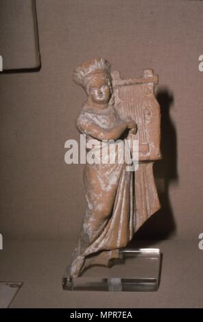 Greek Terracotta, Woman playing Kithera with plectrum, 3rd century BC-2nd century BC Artist: Unknown. Stock Photo