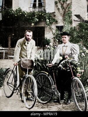 Pierre and Marie Curie, French physicists, preparing to go cycling. Artist: Unknown. Stock Photo