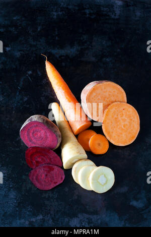 Sliced root vegetables on dark ground Stock Photo