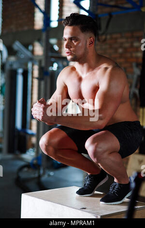 Man doing exercises at gym Stock Photo