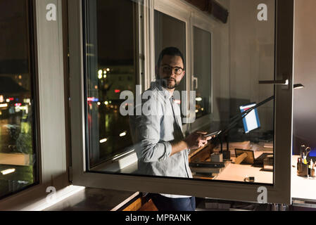 Portrait of businessman working late in office Stock Photo