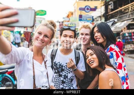 Thailand, Bangkok, Khao San Road, group of friends taking selfie with smartphone Stock Photo