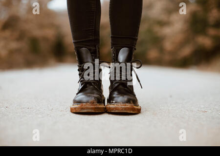 Woman wearing black boots, partial view Stock Photo