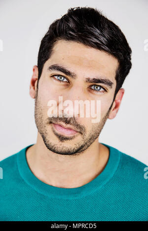 Portrait of young man with blue eyes and stubble Stock Photo