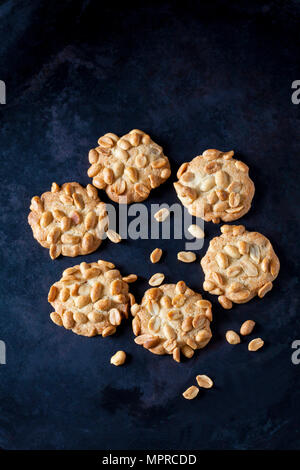 Six peanut cookies on dark metal Stock Photo