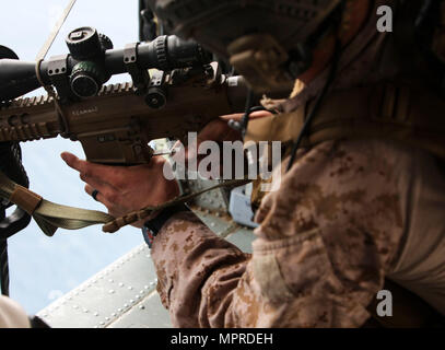 15th Marine Expeditionary Unit is a forward-deployed Marine Air-Ground Task Force of the United States Marine Corps based at Camp Pendleton, California. On April 9, 2017, a Maritime Raid Force sniper prepared his rifle magazine during Amphibious Squadron Marine Expeditionary Unit Integration in the Pacific Ocean. The archival image records live-fire rehearsal prior to Visit Board Search and Seizure operations. Stock Photo