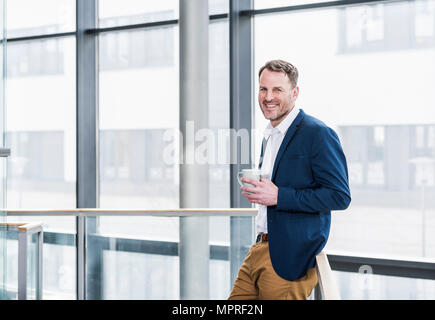 Portrait of smiling businessman having a coffee break Stock Photo