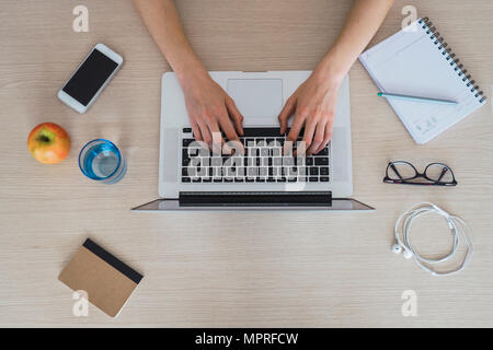 Top view of woman using laptop on table Stock Photo