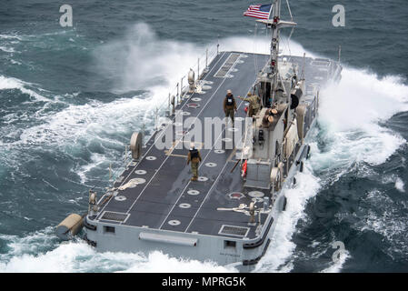 170409-N-OU129-054 POHANG, Republic of Korea (Apr. 9, 2017) Sailors from Navy Cargo Handling Battalion One position a power module to receive an intermediate module unloaded from Navy Maritime Prepositioning Force Ship USNS Pililaau (T-AK 304) using Improved Navy Lighterage System (INLS) off the coast of Pohang, Republic of Korea during Combined Joint Logistics Over the Shore (CJLOTS) April 9. CJLOTS is a biennial exercise conducted by military and civilian personnel from the United States and the Republic of Korea, training to deliver and redeploy military cargo as a part of the large Foal Ea Stock Photo