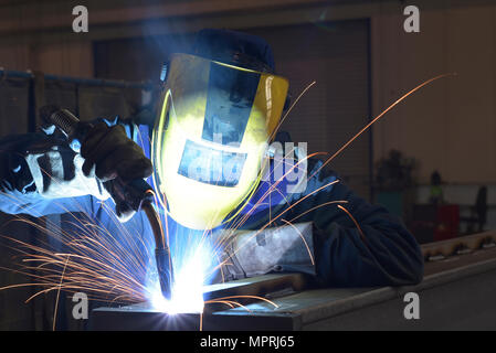 Welder at work in factory Stock Photo