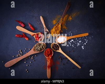 Variety of spices on wooden spoons Stock Photo