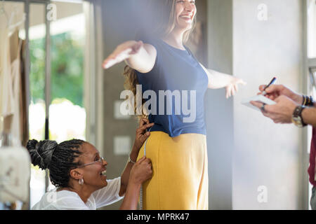 Happy tailor taking measurements Stock Photo