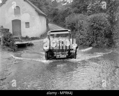 Kitty Brunell fording the River Exe in a Talbot 14/45 sportsman's coupe, Winsfors, Somerset, c1930s. Artist: Bill Brunell. Stock Photo