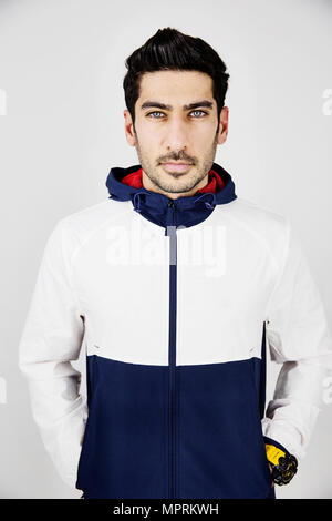 Portrait of young man wearing tracksuit top Stock Photo