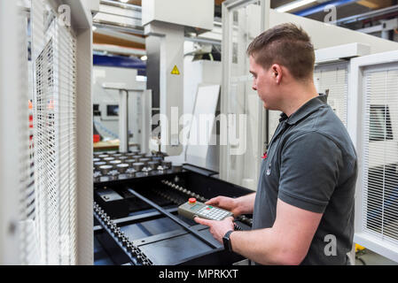 Man operating machine in factory Stock Photo