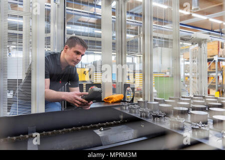 Man operating machine in factory Stock Photo