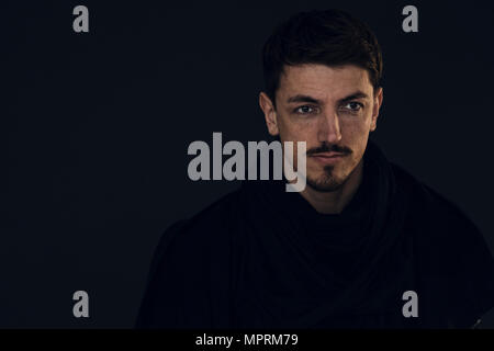 Portrait of bearded man in front of dark background Stock Photo