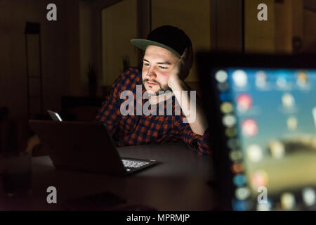 Portrait of freelancer working at night in office Stock Photo