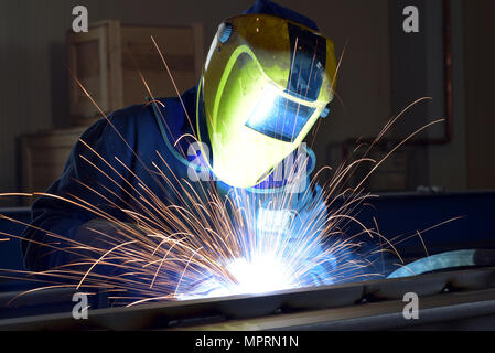 Welder at work in factory Stock Photo