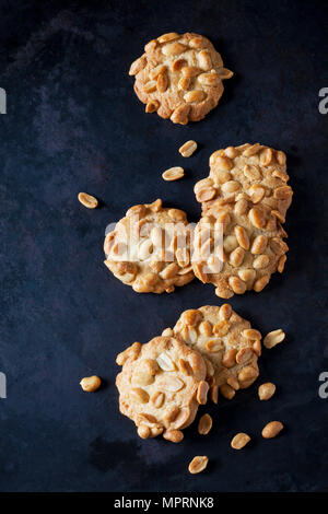 Six peanut cookies on dark metal Stock Photo