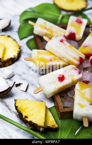 Pina Colada popsicles with candied cherries and pineapple Stock Photo