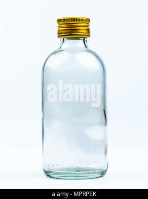 Empty transparent round glass bottle with closed aluminum yellow cap isolated on white background with blank label and copy space. Use for beverage or Stock Photo