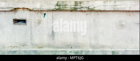 Seamless dirty old concrete wall with long cracks and green moss. Horisontal photo Stock Photo