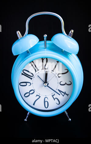Blue alarm clock on black background Stock Photo