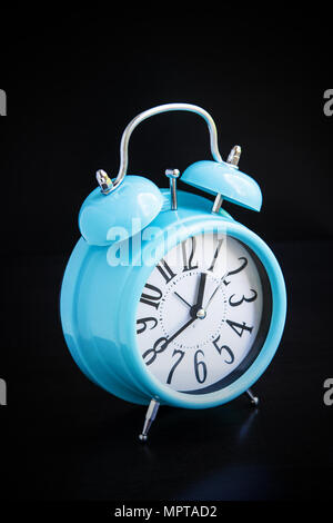 Blue alarm clock on black background Stock Photo