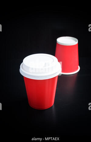 Red coffee cups on black background. Coffee to go Stock Photo