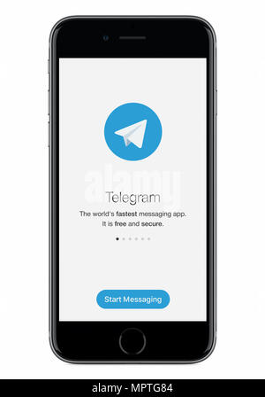 Telegram messenger launch screen with Telegram logo on black Apple iPhone 8 display. Stock Photo