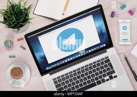 Telegram messenger logo on laptop and smartphone screens. Stock Photo