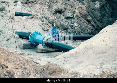 water system pipeline at construction site. City construction of water supply pipeline with gate valves. Construction of drinking water pipes with gat Stock Photo