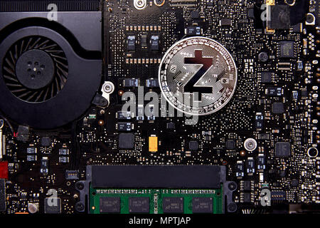 A ZCash physical coin sitting on a computer motherboard with a fan and RAM. Using cryptography to provide enhanced privacy for its users. Stock Photo