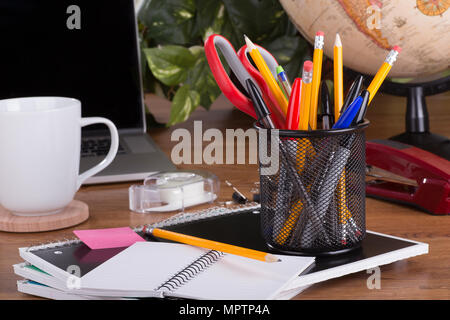 Desktop workspace with an assortment of office supplies, laptop computer and accessories Stock Photo