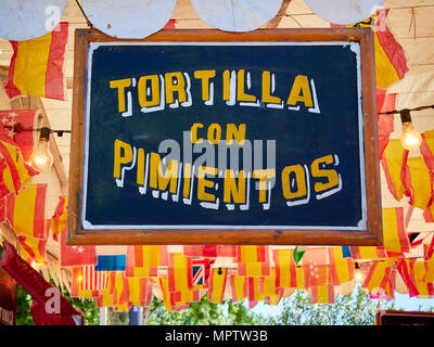 Vintage wooden signboard at a fair announcing a typical Spanish food; Tortilla de patatas con pimientos, Spanish Omelette with peppers. Stock Photo
