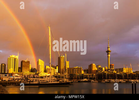 new zealand auckland new zealand north island rainbow after rain storm over auckland harbour waterfront weird colour sky stormy sky auckland nz Stock Photo