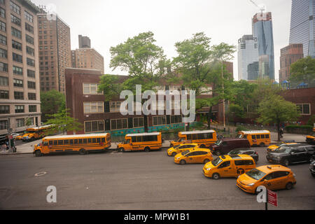 Traffic backs up as vehicles cannot legally pass a discharging school bus as the buses line up in front of PS 33 in Chelsea in New York on Friday, May 18, 2018. (Â© Richard B. Levine) Stock Photo