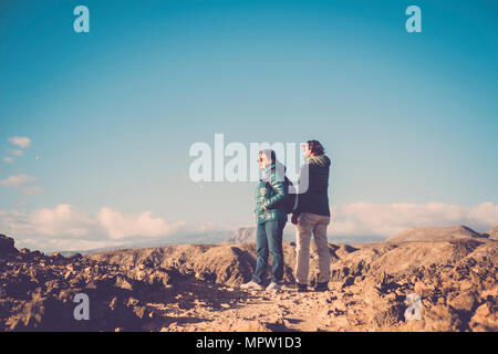 Senior mother and 45 year old son spend time together walking on an isolated path Stock Photo