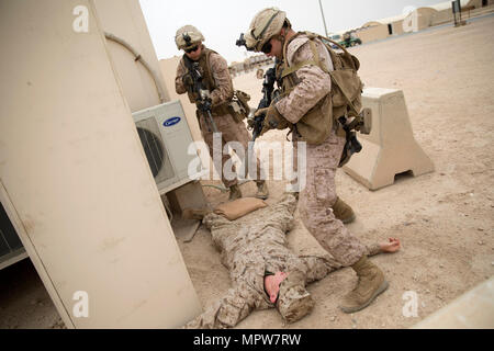 CAMP BEUHRING, KUWAIT (April 11, 2017)— Marines assigned to Lima Co., 3rd Battalion, 6th Marine Regiment, 24th Marine Expeditionary Unit check an enemy combatant played by a fellow Marine during reaction to contact drills at Camp Buehring, Kuwait April 11. The Marines are at Buehring for a sustainment training evolution. The 24th MEU is currently deployed with the Bataan Amphibious Ready Group in support of maritime security operations designed to reassure allies and partners and preserve the freedom of navigation and free flow of commerce in the U.S. 5th Fleet area of operations. Stock Photo