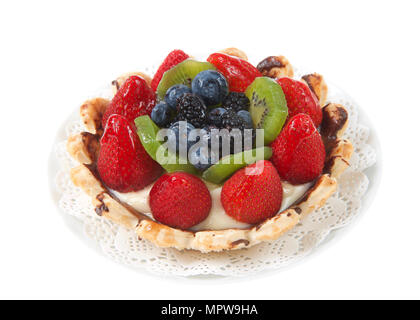 Fresh summer fruit tart with strawberries, kiwi, blueberries, boysenberries on a white doily on plate isolated on white background. Stock Photo