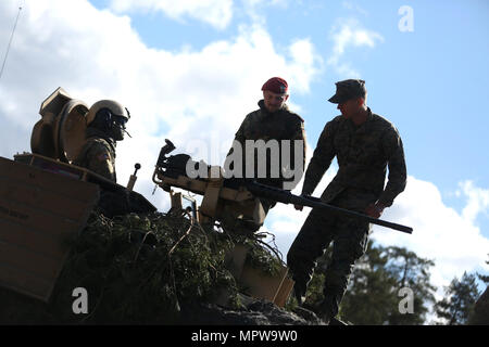 M1A2 Abrams is a third-generation main battle tank of the United States Army manufactured by General Dynamics Land Systems and powered by a Honeywell AGT1500 gas turbine engine. During Exercise Summer Shield on April 17, 2017, at Adazi Training Area, Latvia, a static display featured the tank with allied personnel present. The archival image documents multinational equipment familiarization. Stock Photo