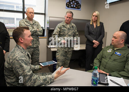 Hanscom Collaboration and Innovation Center Operations Analyst, 1st Lt. Kyle Palko, presents hardened electronic flight bag applications, submitted by private firms, to Air Force Life Cycle Management Center Commander Lt. Gen. John Thompson and U.S. Air Force Chief of Staff, Gen. David L. Goldfein March 28, 2017. Also on hand are EFB PlugTest Program Manager Brittany Ridings and Master Sgt. Benjamin Lewis, Air Mobility Command loadmaster and EFB program expert. Goldfein toured the HCIC and underscored the importance of multi-domain connectivity during his March 28-30 tour of Hanscom. (U.S. Air Stock Photo